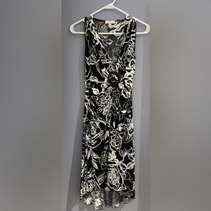 Black printed nylon fabric dress. Falls just below the knee. Free flowing soft